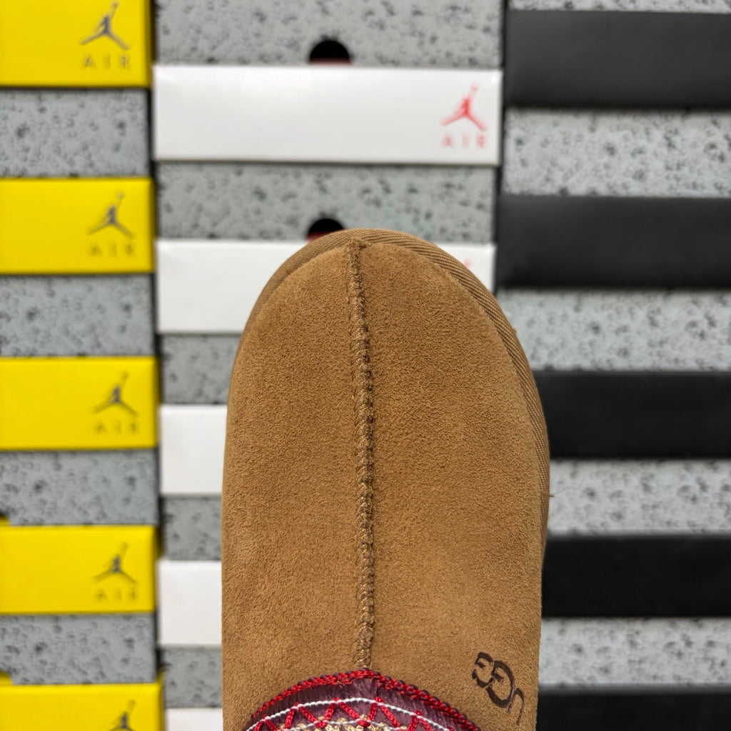 UGG Tazz Platform Slipper – Suede Mule with Shearling Lining, Red & Gold Braided Collar Trim, Red Pull Tab & Chunky Platform Sole in Chestnut